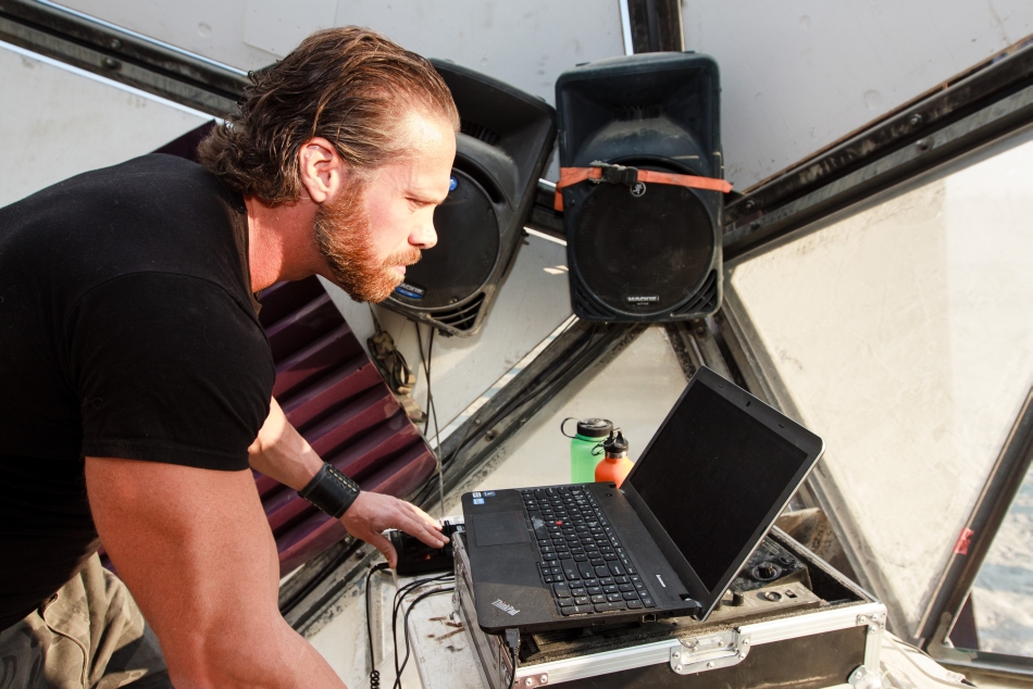 Magnus preparing equipment inside the White Ocean stage at Burning Man 2014